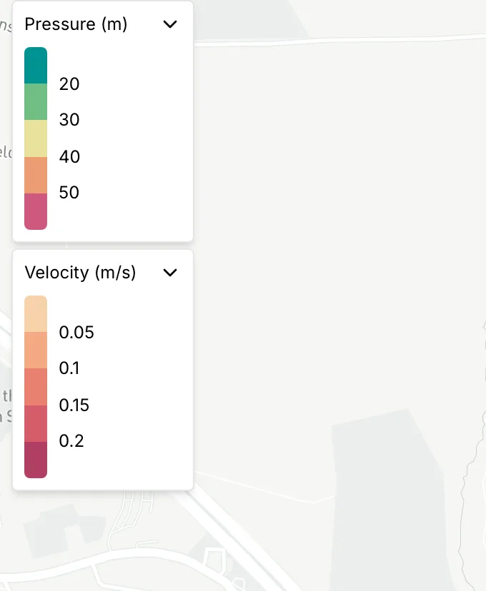 Two legends over the map, one for nodes by pressure and one for links by velocity